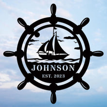 Custom nautical metal sign featuring a ship wheel and sailboat design with personalized name and year, ideal for coastal wall décor