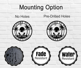 Custom metal wall sign with beach sunset scene, palm trees, and personalized text “Welcome to the Brown’s Oasis Est. 2023” in black powder-coated steel