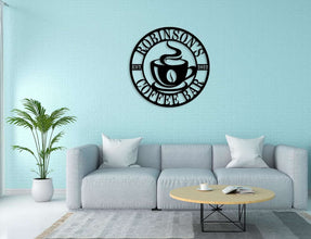 Custom coffee bar metal sign featuring a steaming cup and personalized name text, laser-cut from premium steel with powder-coated black finish.