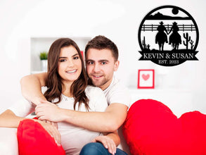 Personalized cowboy couple metal wall art featuring two riders holding hands, custom name and date, rustic western decor, laser-cut steel sign for home or gift