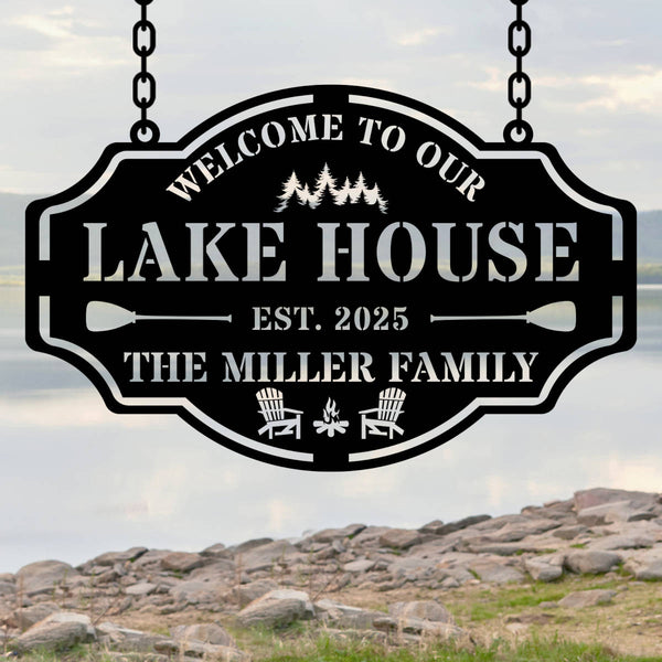 Custom metal lake house sign with family name, trees, paddles, and chairs design, black powder-coated steel, personalized outdoor cabin wall decor.