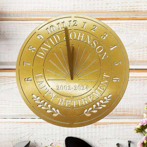Personalized gold metal sundial with custom text "DAVID JOHNSON HAPPY RETIREMENT 2002-2024" and a central gnomon, designed for outdoor garden decoration.
