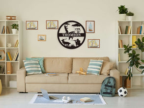 Custom round black metal hunting and fishing sign featuring a fisherman, deer, hunter silhouette, and personalized family name – laser-cut from powder-coated steel for outdoor wall decor.