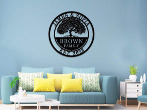 Custom metal family tree sign with names and date laser-cut into black powder-coated steel for personalized home décor.