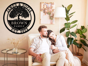 Custom metal family tree sign with names and date laser-cut into black powder-coated steel for personalized home décor.