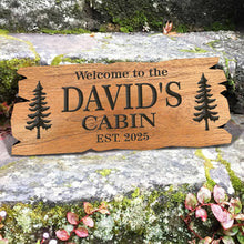 Custom rustic cabin wood sign made of engraved pine with personalized text and tree design, perfect for cabin décor, housewarming, or family gift.