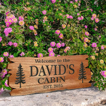 Custom rustic cabin wood sign made of engraved pine with personalized text and tree design, perfect for cabin décor, housewarming, or family gift.