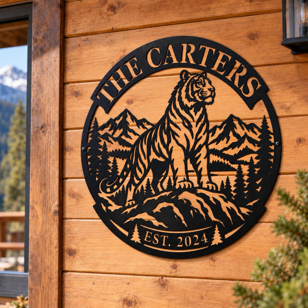 Personalized black tiger mountain metal sign mounted on the wooden exterior wall of a rustic mountain cabin.