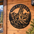 Personalized black tiger mountain metal sign mounted on the wooden exterior wall of a rustic mountain cabin.