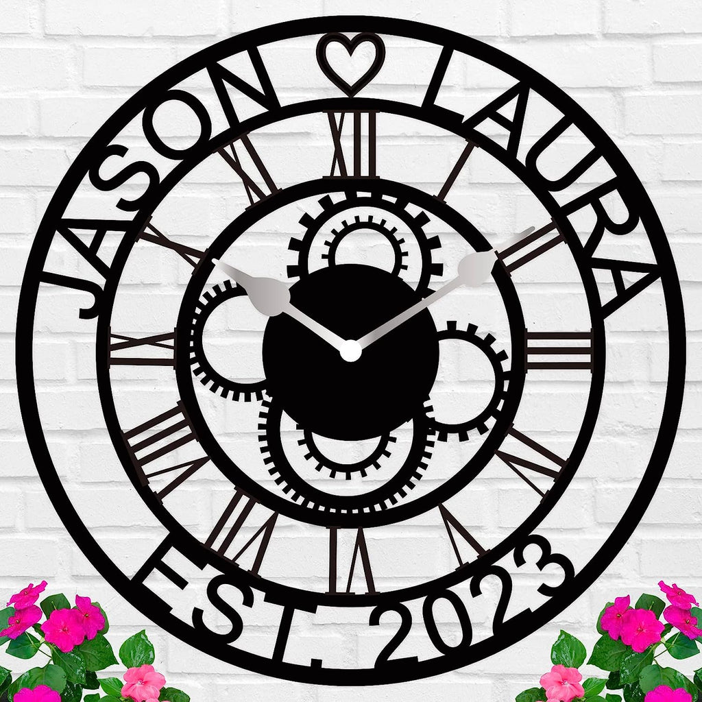 Large personalized black metal wall clock with laser-cut cutout gears, couple names Jason and Laura, center heart icon, established 2023, and Roman numerals.