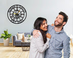 Large personalized black metal wall clock with laser-cut cutout gears, couple names Jason and Laura, center heart icon, established 2023, and Roman numerals.