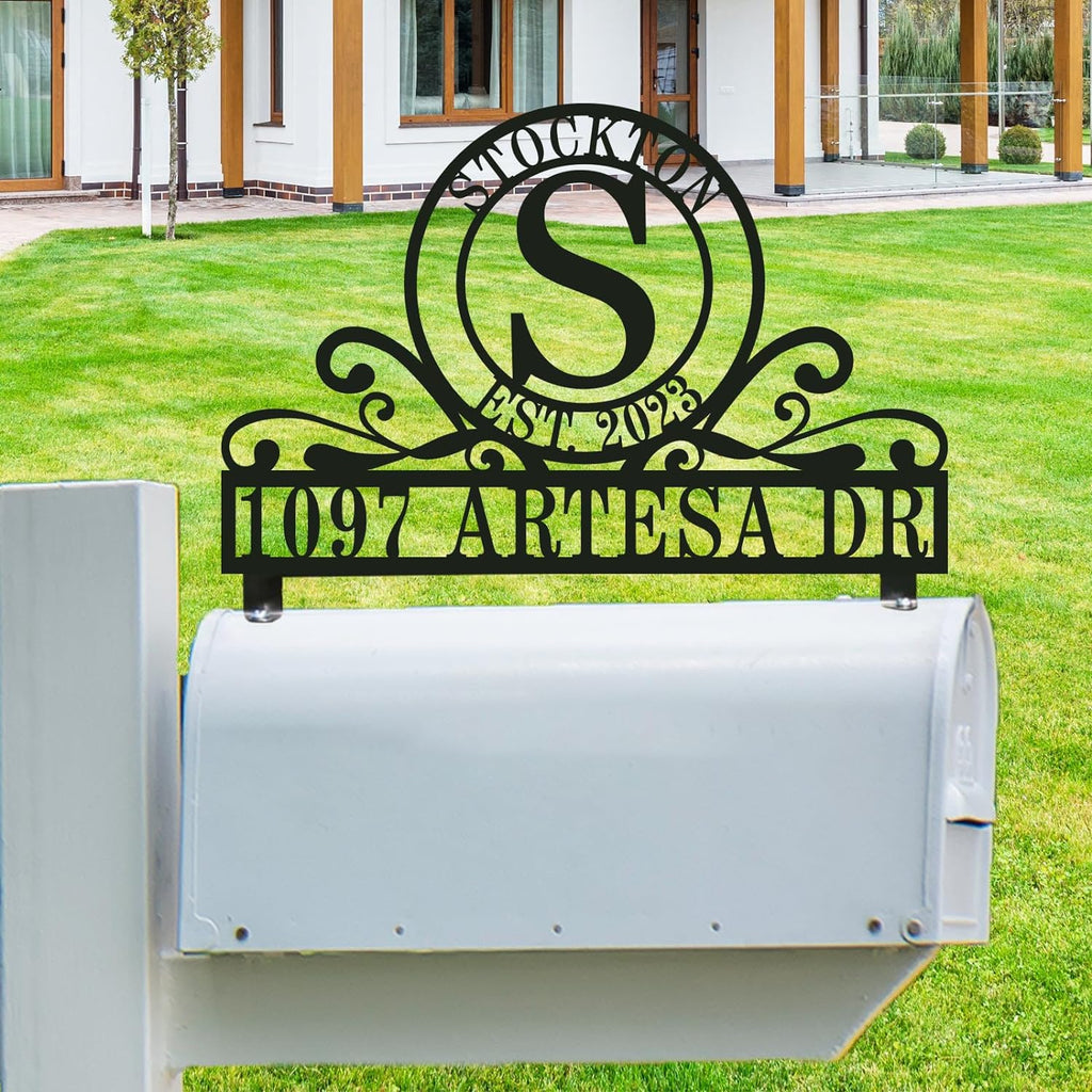 Personalized stainless steel mailbox topper with double-ring monogram, family name, established date, and custom street address in black rust-proof finish.