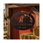 Custom ranch plaque hanging on a red barn with farm name and established year.