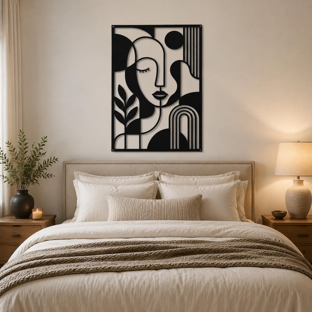 Modern black iron abstract face wall decor above a cozy bedroom bed with neutral interior design