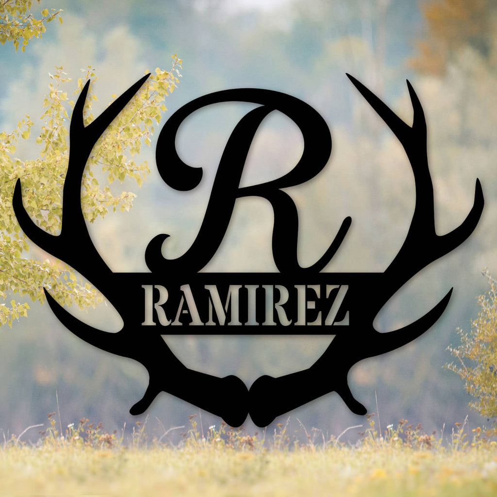 Black laser-cut 14-gauge steel frameless antler monogram sign featuring large script initial R between symmetrical deer antlers with family surname Ramirez in bold banner — custom personalized antler family name metal wall art
