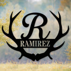 Black laser-cut 14-gauge steel frameless antler monogram sign featuring large script initial R between symmetrical deer antlers with family surname Ramirez in bold banner — custom personalized antler family name metal wall art