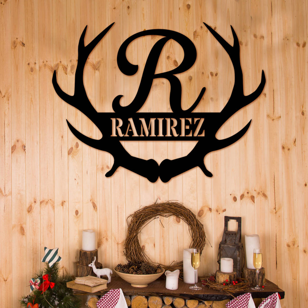 Black laser-cut 14-gauge steel frameless antler monogram sign featuring large script initial R between symmetrical deer antlers with family surname Ramirez in bold banner — custom personalized antler family name metal wall art