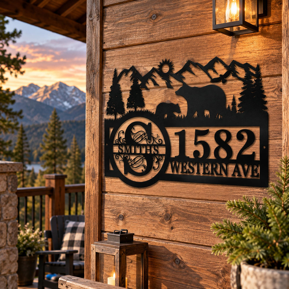 Custom black metal bear and mountain address sign displayed on a rustic mountain cabin.