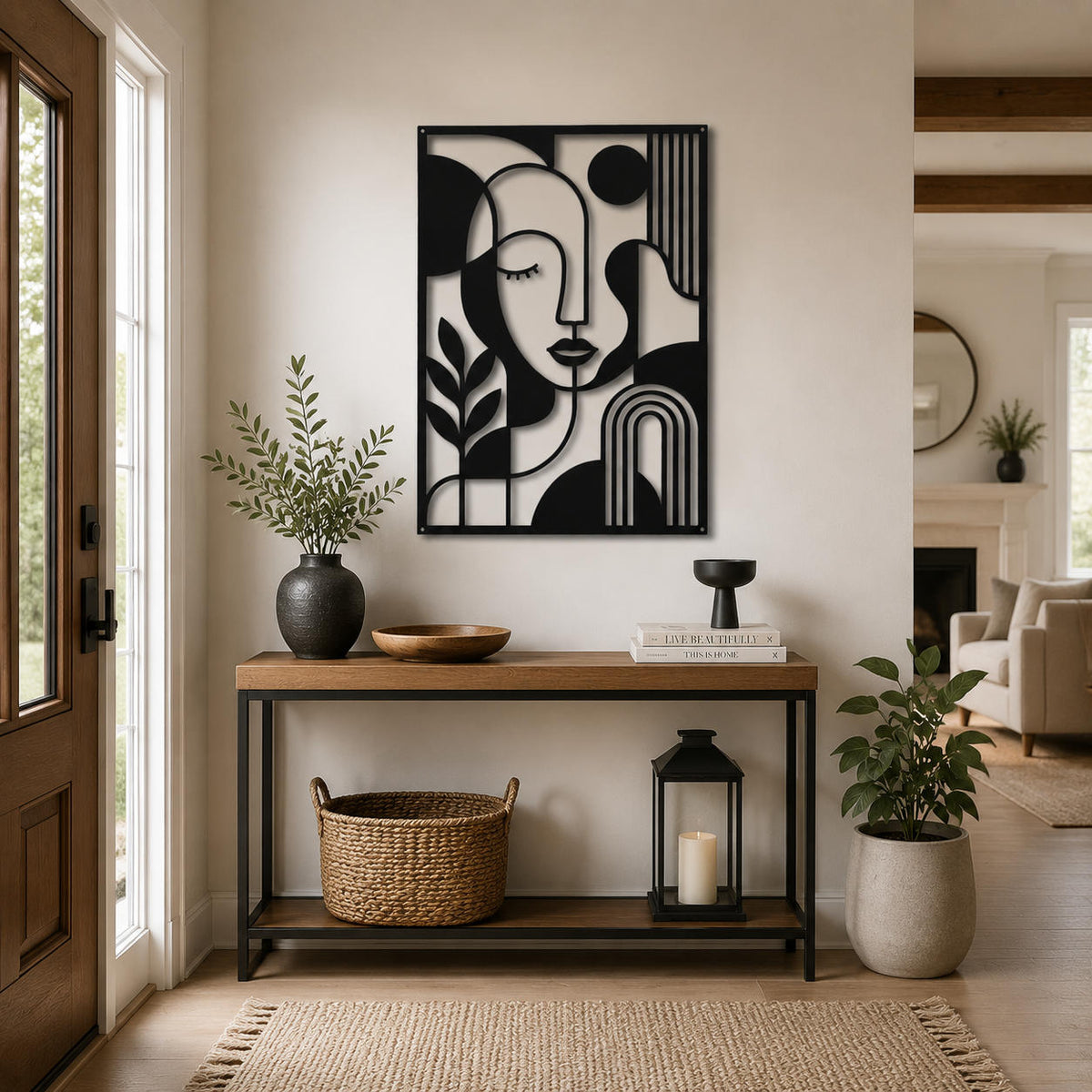 Black metal abstract wall sculpture displayed in a stylish home entryway with console table and plants