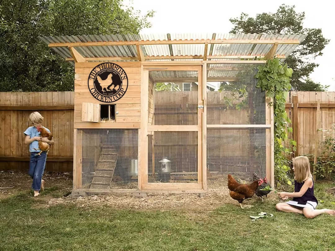 Round custom metal chicken coop sign with a hen and two chicks, personalized with family name and established date, made from durable black steel.