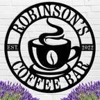 Custom coffee bar metal sign featuring a steaming cup and personalized name text, laser-cut from premium steel with powder-coated black finish.