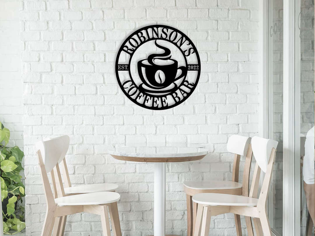 Custom coffee bar metal sign featuring a steaming cup and personalized name text, laser-cut from premium steel with powder-coated black finish.