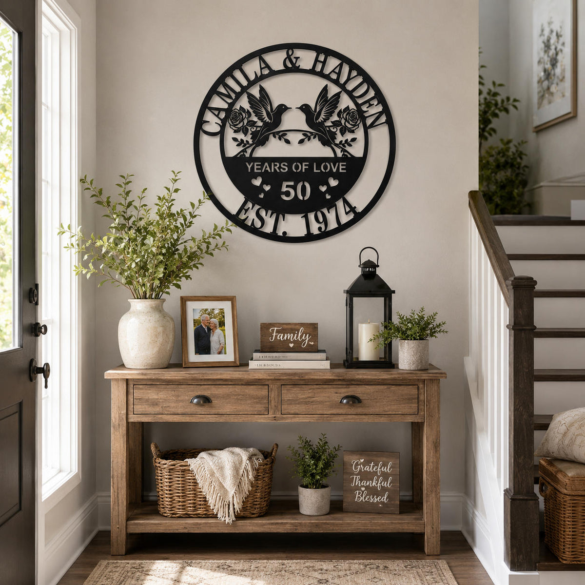 Custom anniversary metal wall art with couple names displayed in an elegant home entryway.
