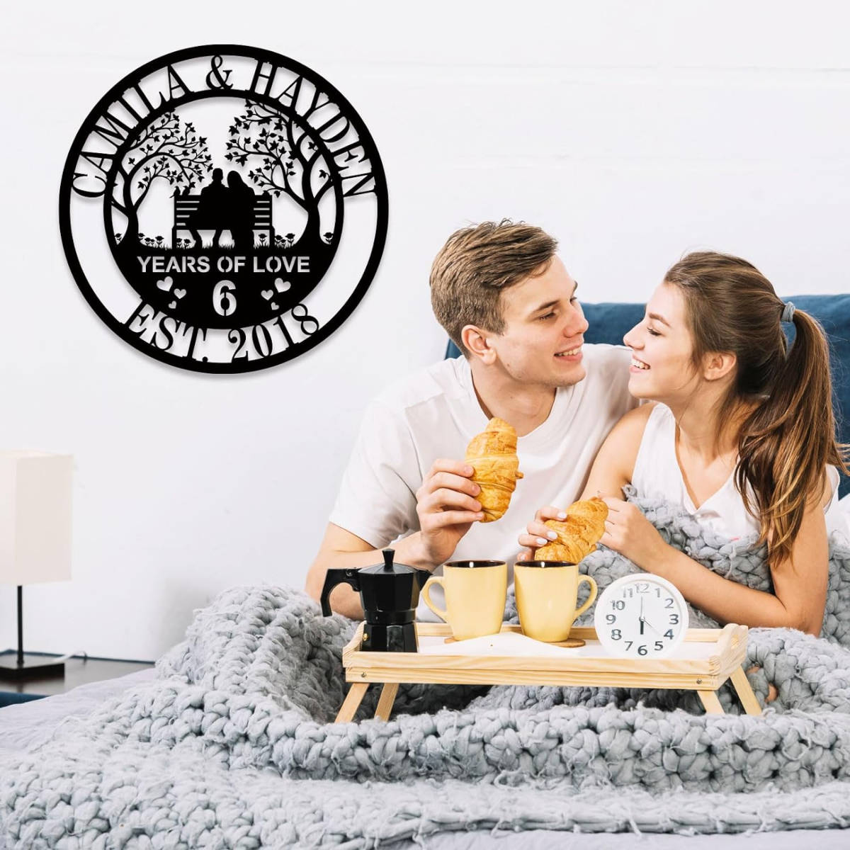 Custom laser-cut steel anniversary sign featuring a couple on a bench with trees, personalized with names, anniversary year, and established date