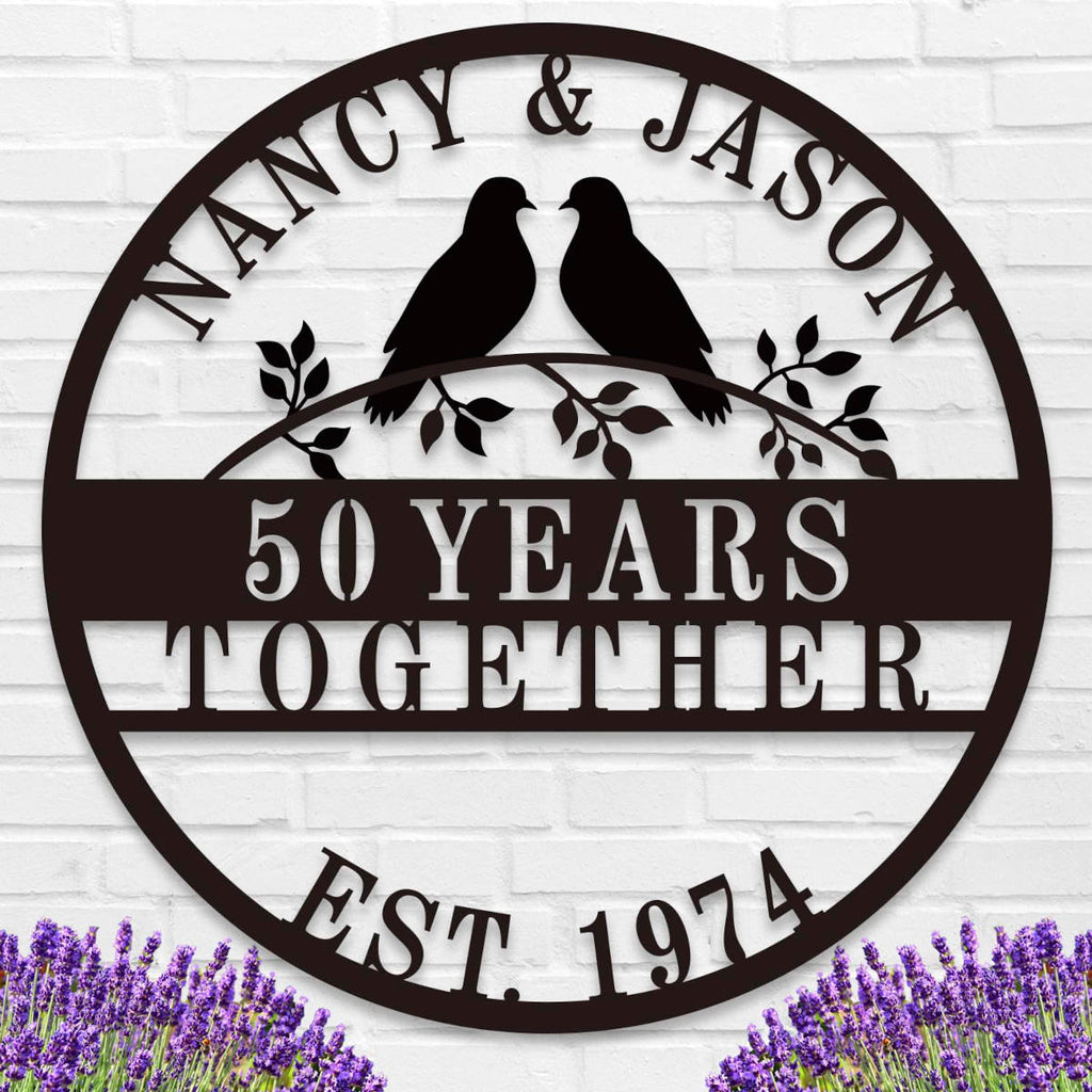 Custom round metal anniversary sign featuring personalized names, years together, and lovebirds on a branch.