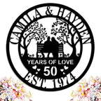 Custom laser-cut steel anniversary sign featuring a couple on a bench with trees, personalized with names, anniversary year, and established date