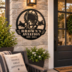 Personalized Brown’s Aviation metal sign displayed on an exterior wall beside a modern home entrance.