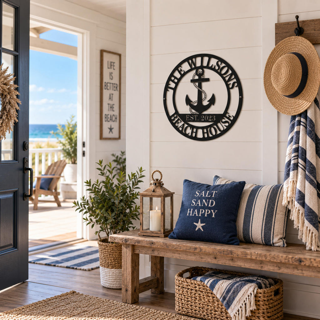 Custom black metal beach house sign with anchor displayed in a bright coastal home entryway.