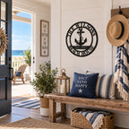 Custom black metal beach house sign with anchor displayed in a bright coastal home entryway.