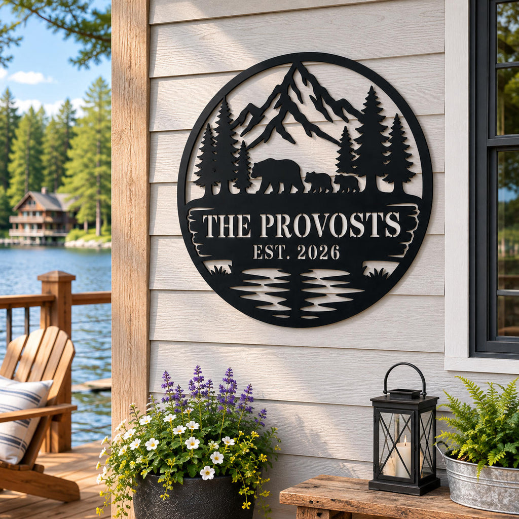 Custom round bear family metal sign mounted on a rustic wood wall at a peaceful lakeside cabin.