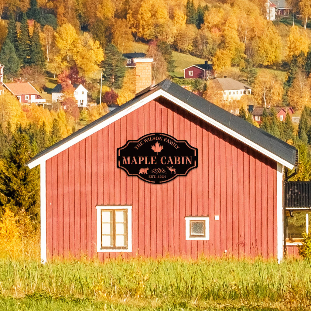 Custom metal cabin sign featuring bear, moose, maple leaf and personalized family name, laser-cut from powder-coated steel