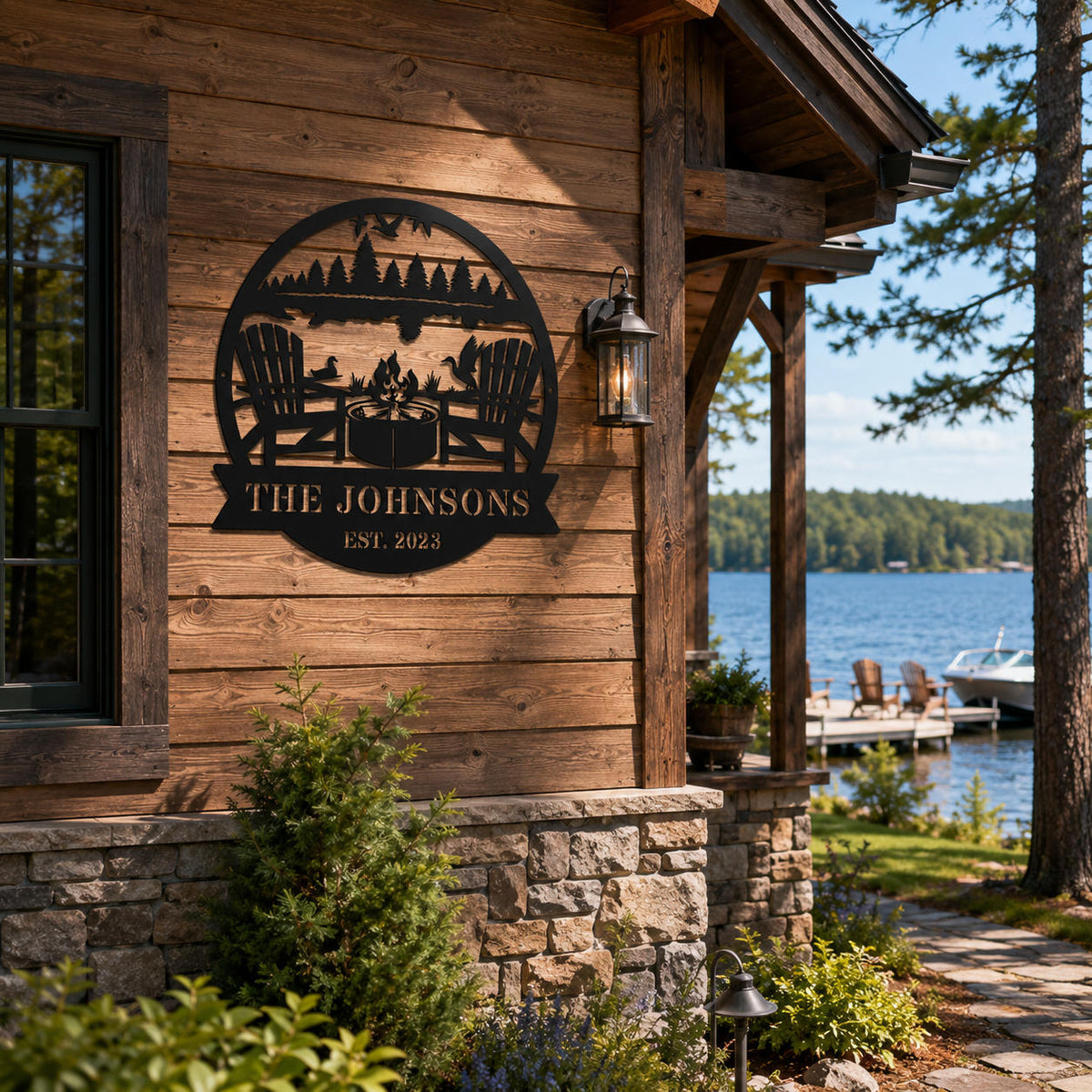 Personalized round metal sign installed on the exterior wall of a lakeside cabin.