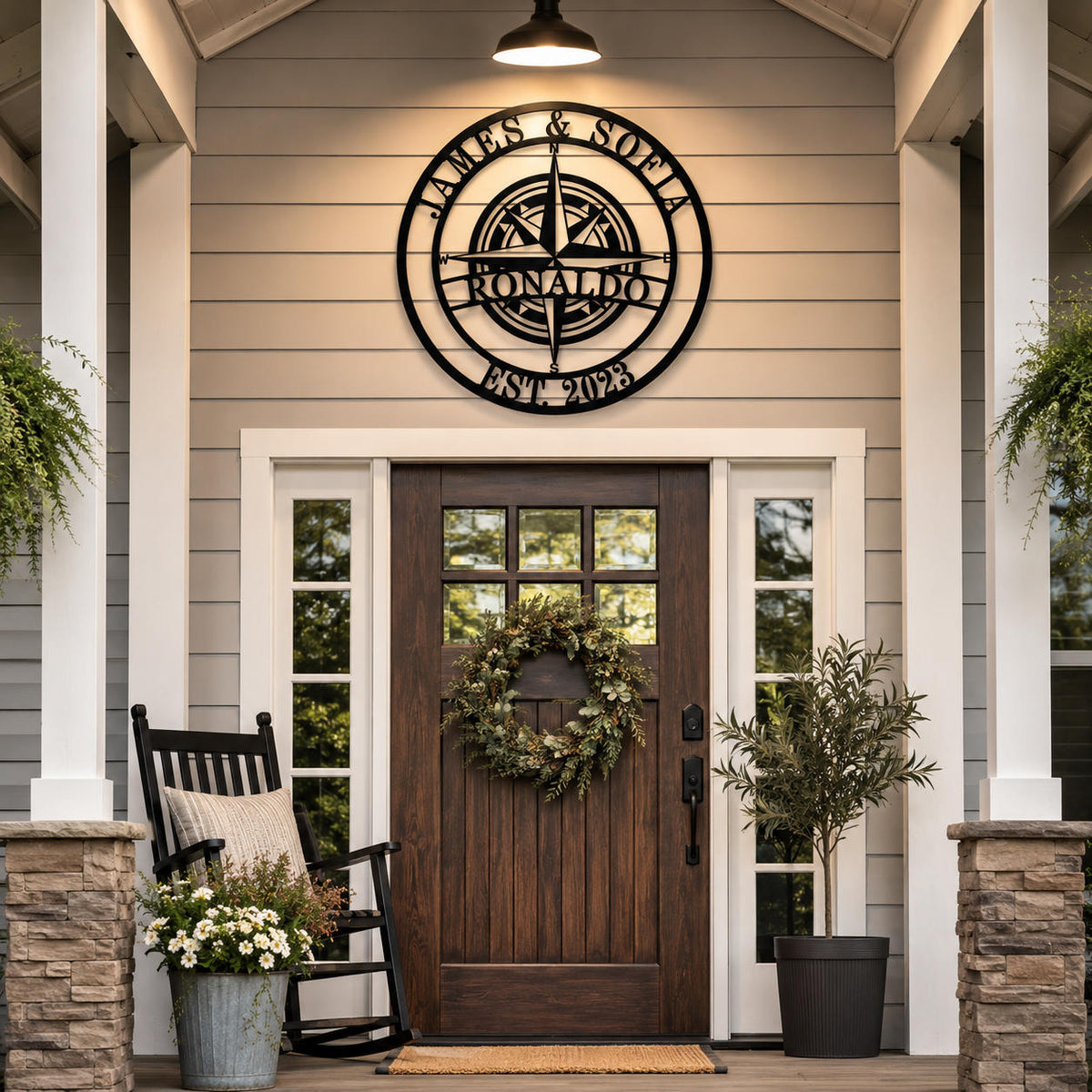 Custom compass metal family name sign mounted above farmhouse front door with personalized surname and established year
