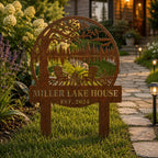 Custom corten steel garden stake sign installed along a rustic garden pathway.