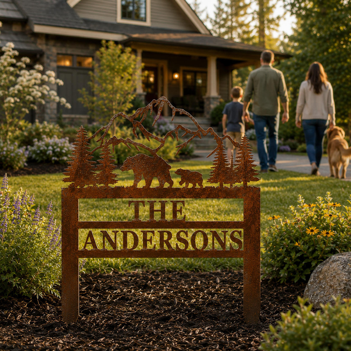 Personalized family name yard sign made from corten steel with bear and mountain scene in landscaped front yard