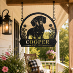 Custom dachshund metal hanging sign suspended by chains on a rustic farmhouse porch.