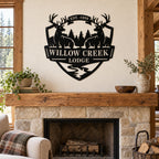 Custom deer lodge metal sign displayed above an oak mantel and stone fireplace.