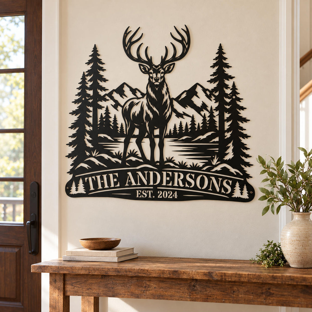 Personalized elk metal wall art decorating a home entryway above a wooden console table.