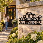 Custom monogram metal address sign displayed at a welcoming residential entrance during golden hour.