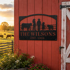 Personalized ranch family metal sign displayed on a red barn exterior wall