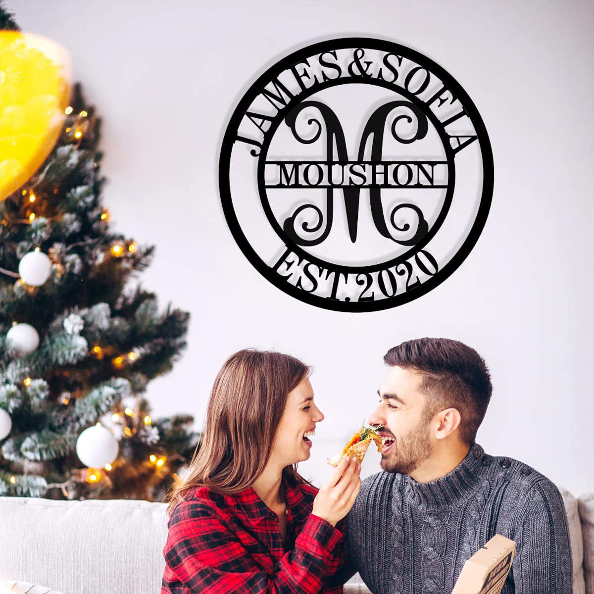 Custom circular metal monogram sign with personalized family name and date.