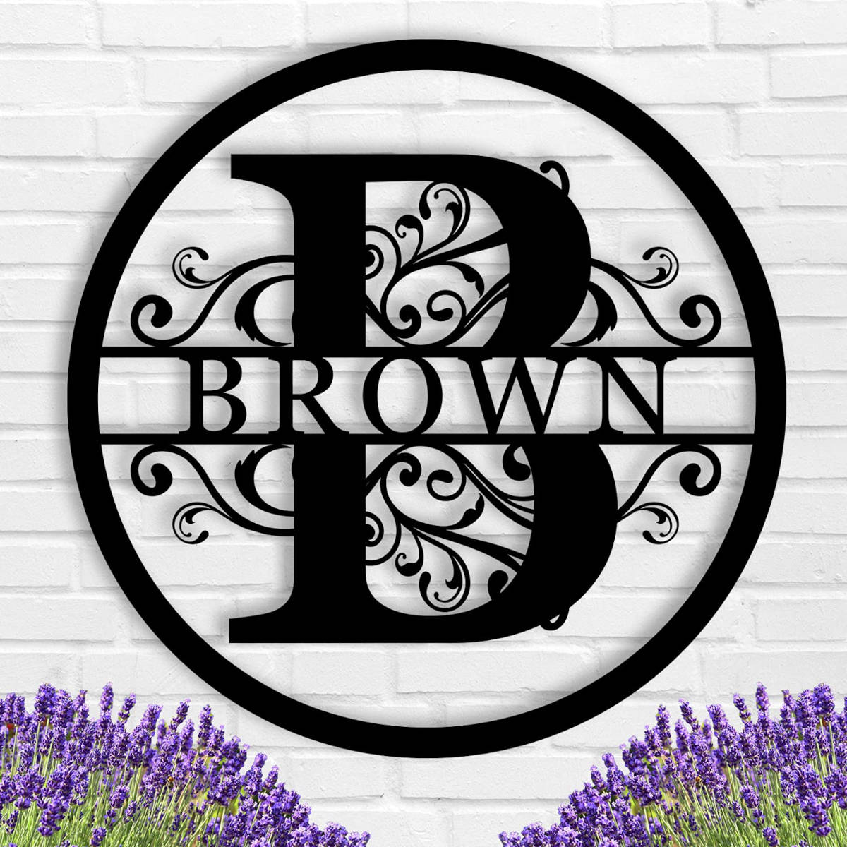 Black circular metal monogram sign with custom family name and botanical patterns.