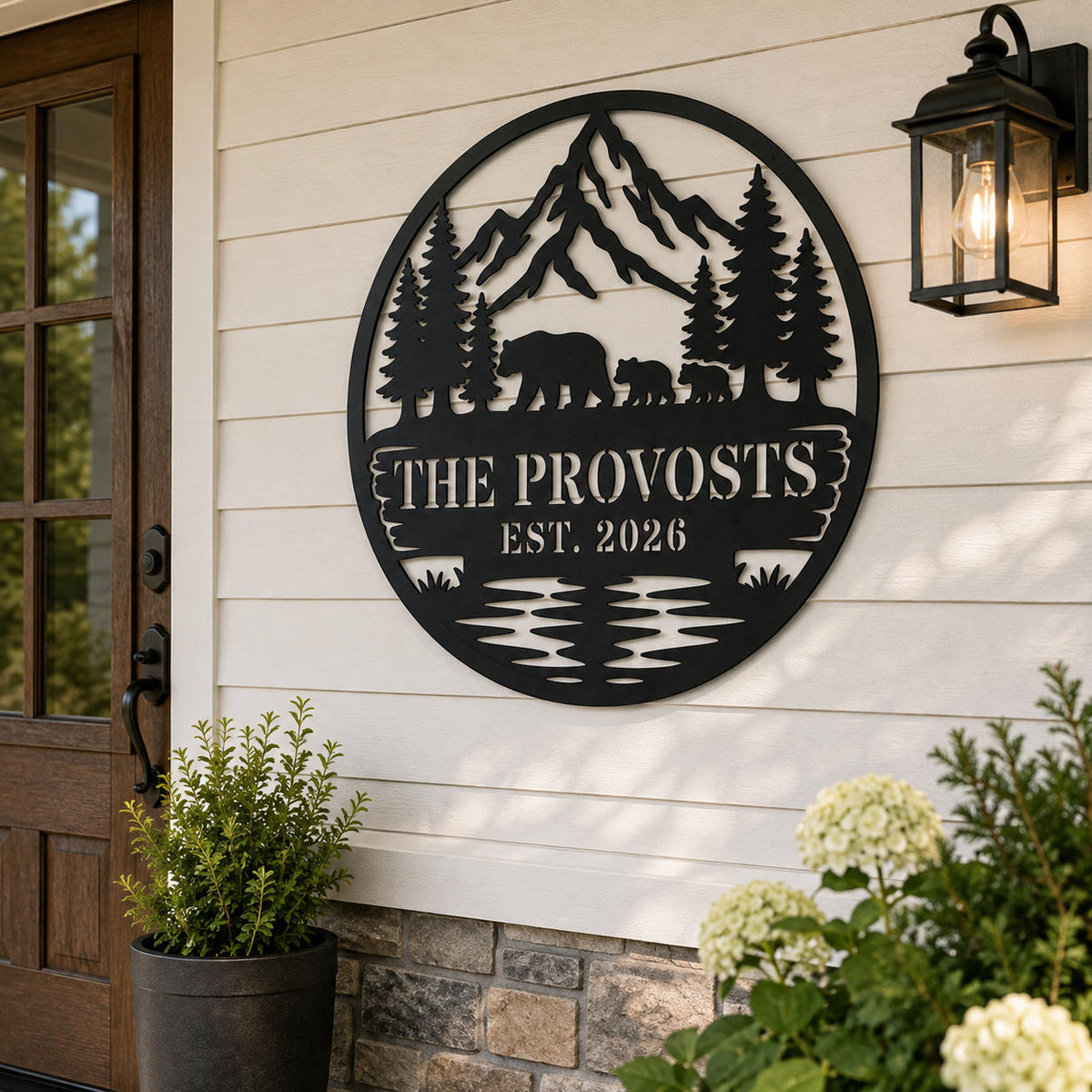Personalized bear family metal sign displayed on a bright American front porch beside a wooden entry door.