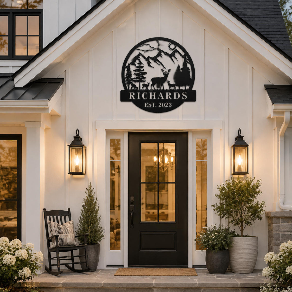 Custom deer mountain metal family name sign displayed above the entrance of a modern farmhouse.
