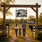 Custom farm entrance sign hanging above a wooden ranch gate with a family, horses, cattle, and golden hour pasture scenery.