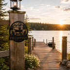 Personalized lake dock metal sign with family name displayed at a wooden lakeside entrance